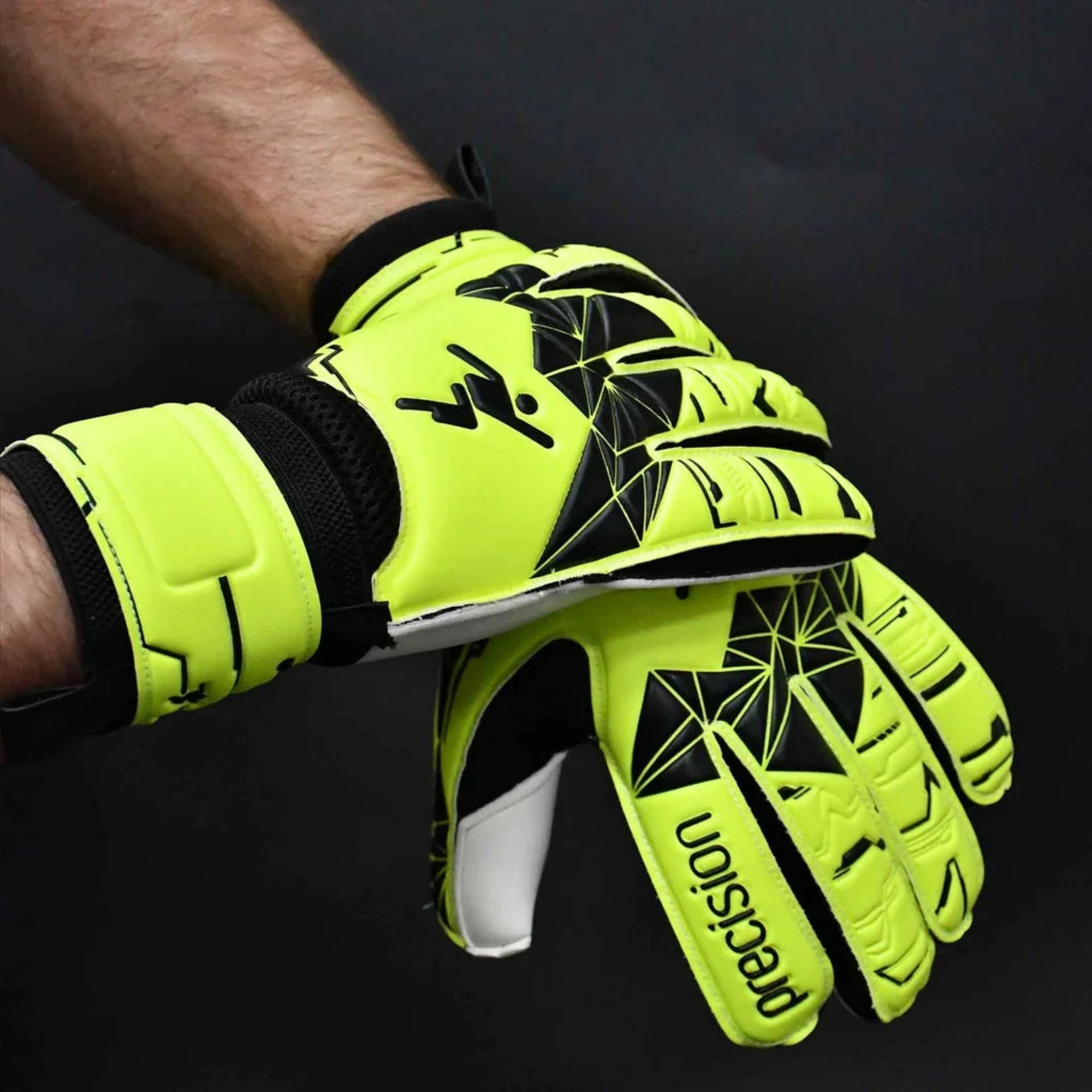 Bright yellow goalkeeper gloves with black patterns on a dark background